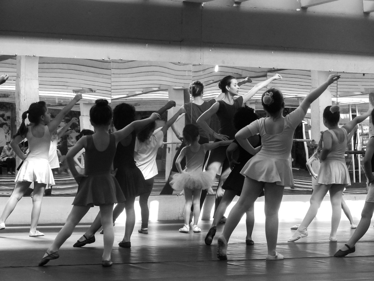 Professeure et jeunes danseuses en cours, photo artistique noir et blanc